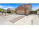 Suburban house featuring an attached two-car garage and concrete driveway at 2909 W Bowker St, Phoenix, AZ 85041