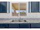 Close-up view of a stainless-steel kitchen sink and granite countertops at 2909 W Bowker St, Phoenix, AZ 85041