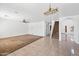 Bright and open living space with a ceiling fan, tile flooring, and staircase access at 2909 W Bowker St, Phoenix, AZ 85041