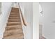 Carpeted staircase with wooden handrail leading to the upper level at 2909 W Bowker St, Phoenix, AZ 85041