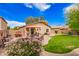 Charming backyard features a patio, lush lawn, colorful flowers, and a cozy seating area for outdoor entertainment at 30266 N Royal Oak Way, San Tan Valley, AZ 85143