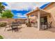 A backyard patio perfect for outdoor living features a cozy pergola, BBQ grill, and ample seating area at 30266 N Royal Oak Way, San Tan Valley, AZ 85143