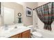Bathroom with a bath and shower, a vanity sink, a framed mirror, and a colorful patterned curtain at 30266 N Royal Oak Way, San Tan Valley, AZ 85143