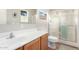 Bathroom featuring a walk-in shower, clean white countertops, and a wood-style cabinet and base at 30266 N Royal Oak Way, San Tan Valley, AZ 85143