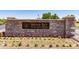 Stone monument sign at Indigo Sky Recreation Center with flowers in front at 30266 N Royal Oak Way, San Tan Valley, AZ 85143