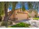 Charming single-story home features a two-car garage and a mature shade tree at 30266 N Royal Oak Way, San Tan Valley, AZ 85143