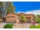 Charming single-story home features a two-car garage and professionally landscaped front yard at 30266 N Royal Oak Way, San Tan Valley, AZ 85143