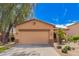 Charming single-story home features a two-car garage and professionally landscaped front yard at 30266 N Royal Oak Way, San Tan Valley, AZ 85143