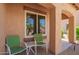 Covered front porch with seating offers a relaxing spot with views to the landscaped front yard at 30266 N Royal Oak Way, San Tan Valley, AZ 85143