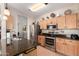 Well-lit kitchen featuring stainless steel appliances, modern cabinets, dark countertops, and an efficient layout for cooking at 30266 N Royal Oak Way, San Tan Valley, AZ 85143