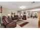 Open concept living room boasts neutral paint, plush carpet, and ample seating at 30266 N Royal Oak Way, San Tan Valley, AZ 85143