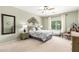 Inviting main bedroom with a cozy bed, a large window for natural light, and a relaxing atmosphere at 30266 N Royal Oak Way, San Tan Valley, AZ 85143