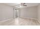 Spacious bedroom features a ceiling fan, wood-look floors, and sliding glass door at 3119 W Cochise Dr # 111, Phoenix, AZ 85051