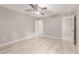 Light-filled bedroom with ceiling fan, wood-look floors, and easy access to ensuite at 3119 W Cochise Dr # 111, Phoenix, AZ 85051