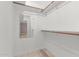 Bright, walk-in closet featuring wooden floors, a mirror and white shelving at 3119 W Cochise Dr # 111, Phoenix, AZ 85051