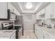 Charming kitchen with stainless appliances, granite counters and white cabinetry at 3119 W Cochise Dr # 111, Phoenix, AZ 85051