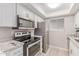 Bright kitchen features stainless appliances, white cabinets and stylish countertops at 3119 W Cochise Dr # 111, Phoenix, AZ 85051