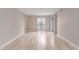 Bright and airy living room with sleek hardwood floors, neutral walls, and a large window with security bars at 3119 W Cochise Dr # 111, Phoenix, AZ 85051