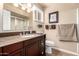 Bathroom vanity features granite countertops, wood cabinets, and a framed mirror at 3237 W Angela Dr, Phoenix, AZ 85053