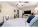 Bright bedroom with neutral walls, ceiling fan, and natural light from an open doorway at 3237 W Angela Dr, Phoenix, AZ 85053
