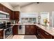 Modern kitchen featuring stainless steel appliances, generous countertop space, and natural light from the window at 3237 W Angela Dr, Phoenix, AZ 85053