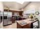 Bright kitchen featuring stainless steel appliances, lots of cabinets, and a vaulted ceiling with skylight at 3237 W Angela Dr, Phoenix, AZ 85053