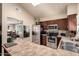 Open kitchen with stainless steel appliances and a view into dining and living area at 3237 W Angela Dr, Phoenix, AZ 85053