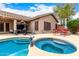 Private backyard features a pool, spa, covered patio, and outdoor dining space at 3519 E Bridgeport Pkwy, Gilbert, AZ 85295