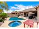 Beautiful backyard featuring a pool, spa, covered patio, outdoor seating, and barbecue area at 3519 E Bridgeport Pkwy, Gilbert, AZ 85295