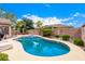 Lush backyard with a sparkling pool, mature trees, and a charming patio area at 3519 E Bridgeport Pkwy, Gilbert, AZ 85295