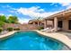 Inviting backyard pool area with lounge chairs, beautiful landscaping, and covered patio at 3519 E Bridgeport Pkwy, Gilbert, AZ 85295