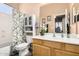 Charming bathroom featuring a single vanity, bathtub with a shower, and decorative floral accents at 3519 E Bridgeport Pkwy, Gilbert, AZ 85295