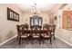 A formal dining room with a large wooden table, upholstered chairs, and a decorative china cabinet at 3519 E Bridgeport Pkwy, Gilbert, AZ 85295