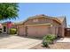 Home exterior showcasing a three-car garage, desert landscaping, and a well-maintained driveway at 3519 E Bridgeport Pkwy, Gilbert, AZ 85295
