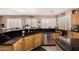 An elegant kitchen area with black countertops, stainless steel appliances and ample sunlight at 3519 E Bridgeport Pkwy, Gilbert, AZ 85295