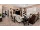 Cozy living room featuring tile flooring, comfortable seating, and open access to other living spaces at 3519 E Bridgeport Pkwy, Gilbert, AZ 85295