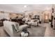 Open-concept living area with tile and carpet flooring, ceiling fan, and access to the kitchen and dining spaces at 3519 E Bridgeport Pkwy, Gilbert, AZ 85295