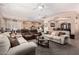 Spacious living room with comfortable seating, ceiling fan, and open floor plan connecting to the kitchen and dining area at 3519 E Bridgeport Pkwy, Gilbert, AZ 85295