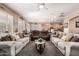 Bright living room showcasing neutral tones, plantation shutters, and open access to the kitchen at 3519 E Bridgeport Pkwy, Gilbert, AZ 85295