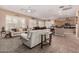 Inviting living space with tile flooring, plantation shutters, and easy access to the kitchen and dining area at 3519 E Bridgeport Pkwy, Gilbert, AZ 85295