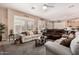 Comfortable living room with plantation shutters, neutral décor, and an open layout leading to the kitchen area at 3519 E Bridgeport Pkwy, Gilbert, AZ 85295