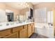 A primary bath featuring double sinks, ample counter space and a soaking tub at 3519 E Bridgeport Pkwy, Gilbert, AZ 85295