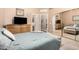 Relaxing bedroom boasts sliding mirrored closet doors and a king bed with blue and beige linens at 3519 E Bridgeport Pkwy, Gilbert, AZ 85295