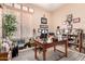 Bright home office filled with artwork and diplomas, featuring a desk, chair, and a window with wood blinds at 3519 E Bridgeport Pkwy, Gilbert, AZ 85295