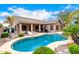 Inviting pool area with covered patio, lounge chairs, and lush landscaping perfect for outdoor relaxation and entertaining at 3519 E Bridgeport Pkwy, Gilbert, AZ 85295