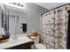 Well-lit bathroom with an artistic shower curtain, a vanity, and a toilet for your comfort at 3687 E Leslie Dr, Gilbert, AZ 85296