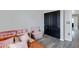 Bedroom featuring a cozy seating area and a dark sliding door closet, creating a charming retreat at 3687 E Leslie Dr, Gilbert, AZ 85296