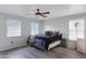 Bedroom with ceiling fan, large windows, and a dark velvet comforter atop the bed for a cozy and inviting atmosphere at 3687 E Leslie Dr, Gilbert, AZ 85296