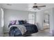 Comfortable bedroom featuring a ceiling fan, neutral-toned walls, and a plush bed with decorative pillows at 3687 E Leslie Dr, Gilbert, AZ 85296