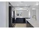 Modern kitchen with black cabinets, stainless steel appliances, granite countertops, and light wood floors throughout at 3687 E Leslie Dr, Gilbert, AZ 85296